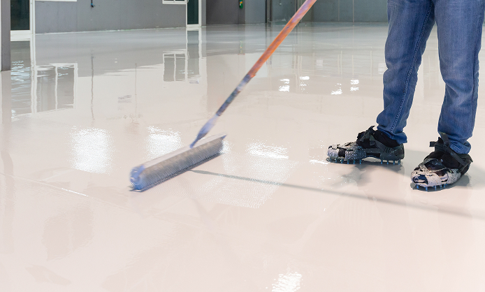 Two people are cleaning the floor